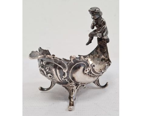 Continental silver trinket dish, oval with scroll and cherub handle, foliate scroll decorated, on four scroll supports, Londo