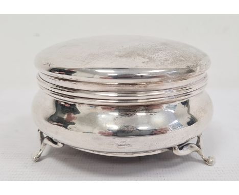 George V silver trinket box with hinged lid opening to reveal blue silk interior, weighted base, the whole raised upon three 