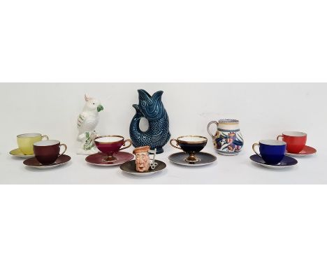 Poole pottery cup, a Dartmouth pottery blue glazed fish guggle jug, a miniature toby jug, part porcelain tea services and a c