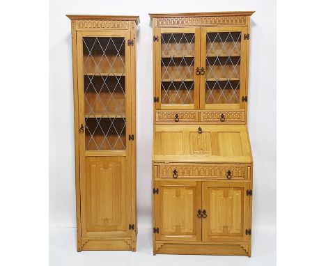 Modern light oak bureau bookcase, the moulded pediment above leaded glazed doors enclosing shelves, above two drawers, above 