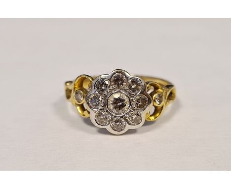 18ct gold and diamond cluster ring, flowerhead-pattern with one diamond to centre and surround of eight smaller stones, flank
