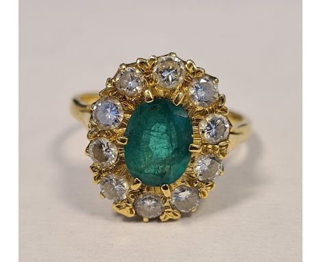 18ct yellow gold emerald and diamond cluster ring, the central oval mixed-cut emerald (estimated weight 1.5ct), surrounded by