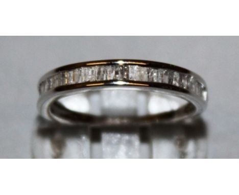 A ZIRCON HALF ETERNITY RING set in 9ct white gold.