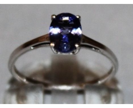 A TANZANITE OVAL DRESS RING set in 9ct white gold.