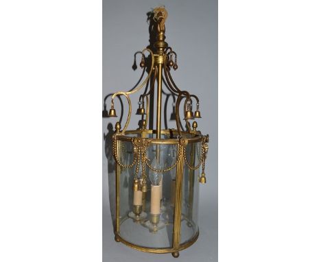 A GOOD 19TH CENTURY CIRCULAR GILT METAL HANGING LANTERN, hung with bell and garlands with ribbons. 25ins high, 10ins diameter