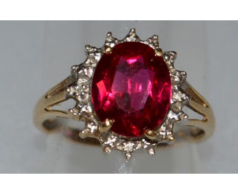 A RUBY AND DIAMOND CLUSTER RING.