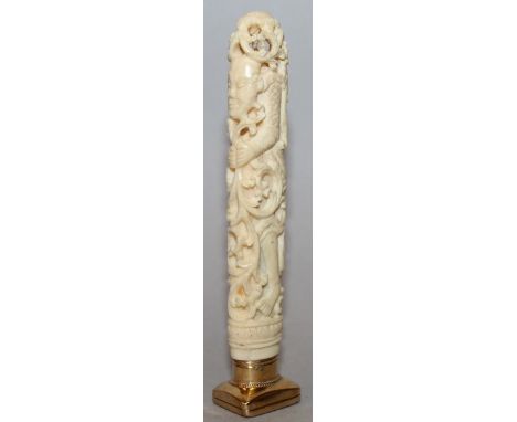 A GOOD CARVED AND PIERCED IVORY HANDLED DESK SEAL, the rounded rectangular cornelian intaglio incised with a classical male p