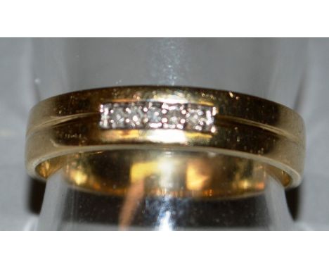 A 9CT GOLD RING set with five diamonds.