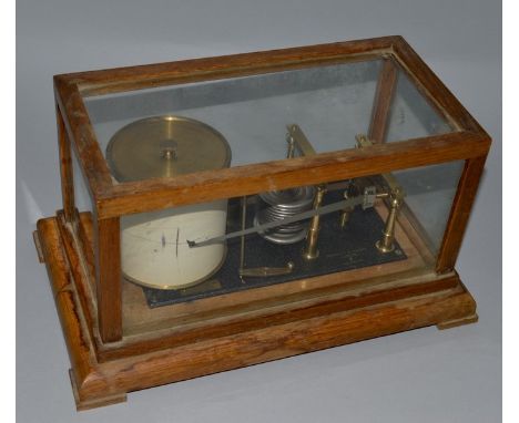 A 1920'S OAK BAROGRAPH by NEGRETTI & ZAMBRA 28/31 in Hg No. R/33657 in a glass case with lift off top.  13.5ins wide overall.