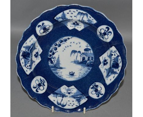 AN 18TH CENTURY ENGLISH PORCELAIN PLATE with scalloped rim painted with circular and fan panels containing flowers or seascap