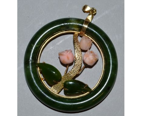 A GOOD CIRCULAR JADE PENDANT set with coral lilies of the valley.