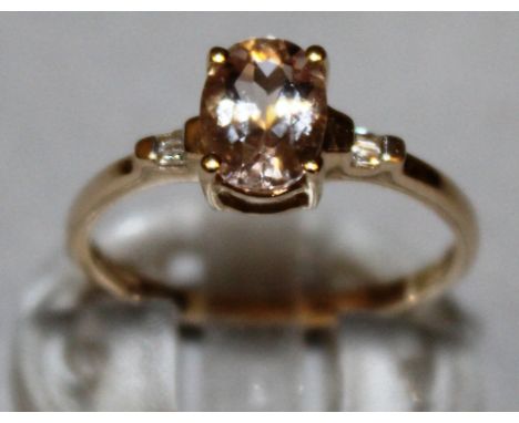 A MORGANITE DRESS RING with zircon shoulders, set in 9ct yellow gold.