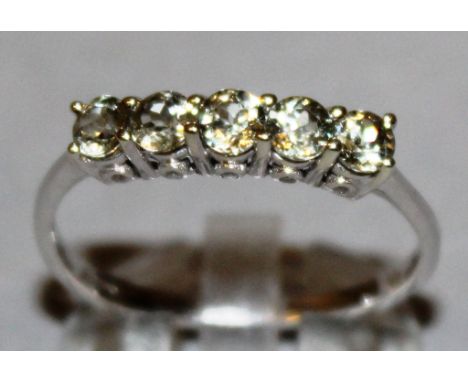 A LARGE FITTING FIVE STONE ZIRCON RING set in 9ct white gold.