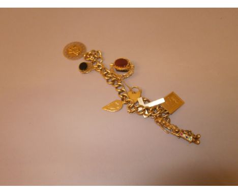 A 9CT GOLD CHARM BRACELET set with eight fish and charms. 48 grams.