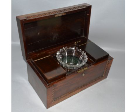 A REGENCY ROSEWOOD TEA CADDY, the lid and front with gadroon carved decoration, the interior fitted with two caddies and a cu