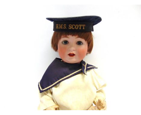 A CATTERFELDER PUPPENFABRIK BISQUE SOCKET-HEAD DOLL with a short brown wig, sleeping blue-grey glass eyes, and an open mouth 