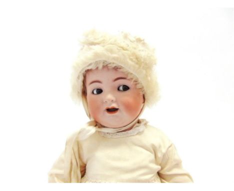 A SIMON & HALBIG BISQUE SOCKET-HEAD DOLL with a short brown wig, 'flirty' side-glancing brown glass eyes, and an open mouth, 