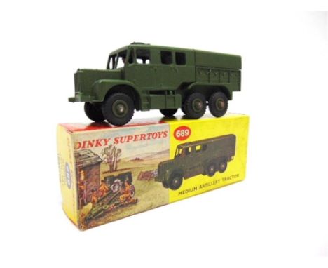 A DINKY NO.689, MEDIUM ARTILLERY TRACTOR olive green with matching grooved hubs, very near mint, boxed, in a yellow pictorial
