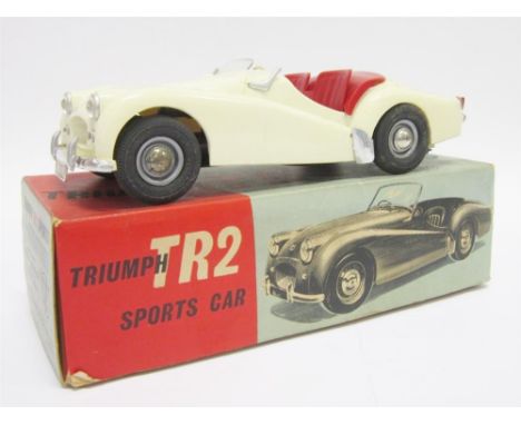 A VICTORY INDUSTRIES 1/18 SCALE TRIUMPH TR2 SPORTS ivory with red seats, fitted with a battery-operated motor (untested), gen