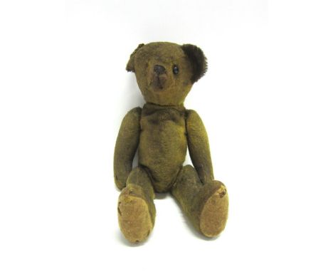A GOLD MOHAIR TEDDY BEAR circa 1920, with boot button eye (one missing) and a horizontally stitched nose, on a jointed body w