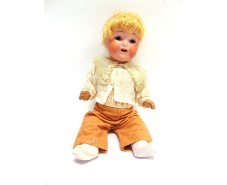 AN ARMAND MARSEILLE BISQUE SOCKET-HEAD DOLL with a cropped blonde wig, sleeping brown glass eyes, and an open mouth with two 