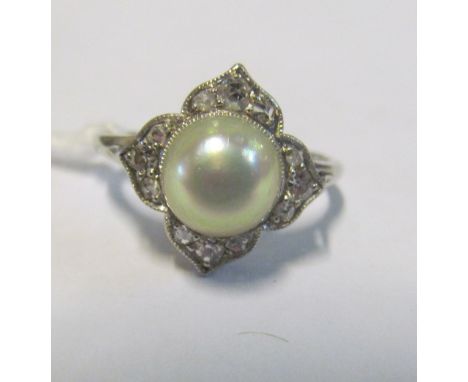 A pearl and illusion set diamond ring