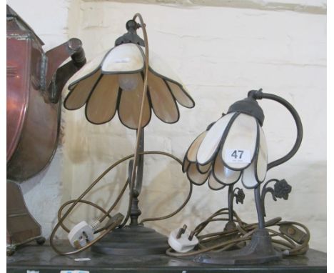 A cream and metal Tiffany style table lamp and a pair of similar smaller lamps