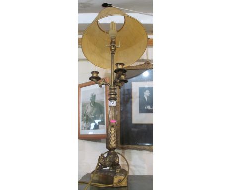 A brass three branch candle lamp with shade