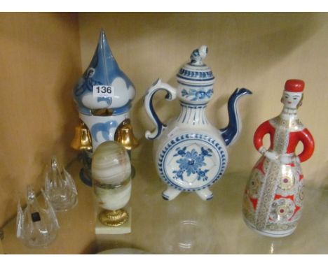 A USSR flask in the form of a Russian lady, china temple ornament with bells, a blue and white teapot, onyx lighter  and two 