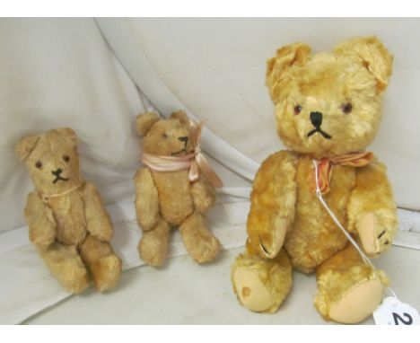 A vintage small golden plush teddy bear and two other smaller bears