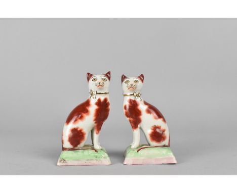 A Pair of Porcelain Studies of Cats, Modelled Seated on Cushion in the Liver Colourway, 10cm high 