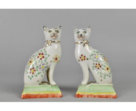A Pair of Porcelain Studies of Cats, Modelled Seated on Cushion, 10cm high 