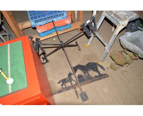 A metal weather vane with horse decoration