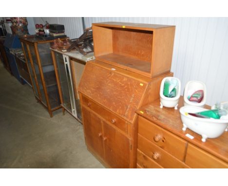 A modern oak bureau and oak book shelf above