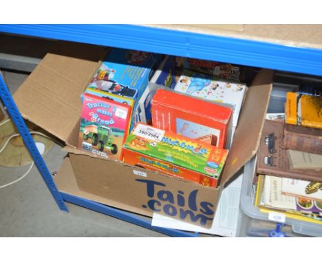 A box of children's games and Tractor Ted DVDs