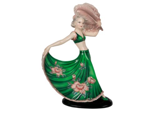 Art deco figure of a dancer dressed lavishly in green with pink flowers, holding a large pink feather and the ends of her ski