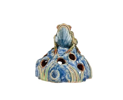 A stunning glazed Doulton Ware model molded as a green frog resting atop of a blue rock accented with green leaves. Royal Dou