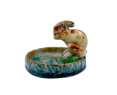 A glossy ceramic blue and gray tray with a brown spotted rabbit seated on the edge. Doulton Lambeth and '8756' stamped on the