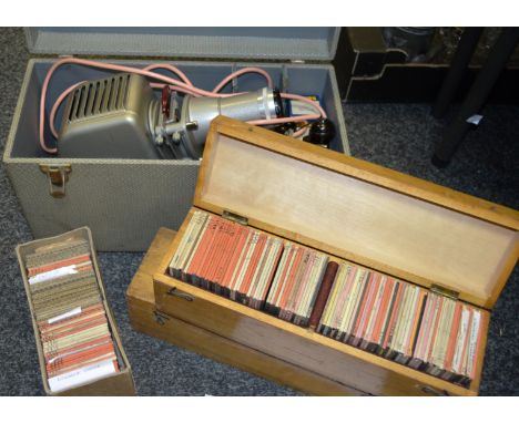 An Aldis slide projector, cased; three boxes of magic lantern slides, mainly geographical images