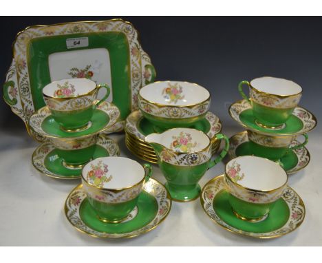 A Spode Copeland part tea service,decorated with floral sprigs on an apple green ground surrounded by a gilt border