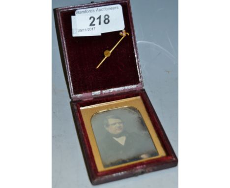 A Victorian ambrotype portrait depicting a sophisticated gentleman of title; a yellow coloured tie pin, the head in the form 