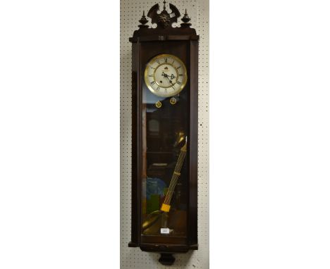 A Woodhouse Marketing (clocks)Ltd. drop pendulum  wall clock, enamel dial , twin winding holes
