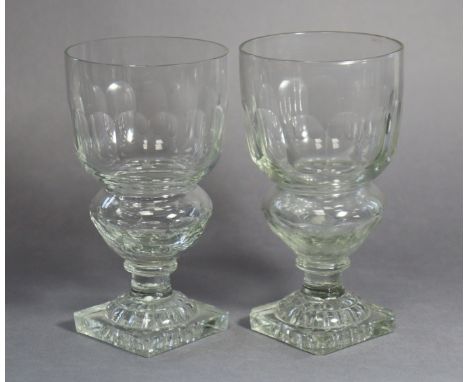 A pair of early 19th century style cut glass drinking glasses with fluted bodies on faceted hollow stems &amp; square ‘lemon-