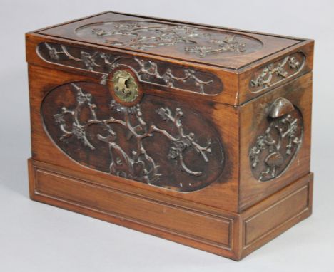 A late 19th/early 20th century Chinese carved hardwood trunk decorated to all sides with birds amongst blossoming prunus bran
