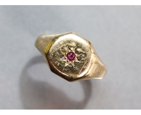 A 9ct. gold ring gypsy-set small ruby; size: S; 4.8 gm.