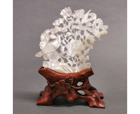 An early 20th century Chinese hand carved mother-of-pearl shell on hardwood stand, a beautiful carving of four birds in among