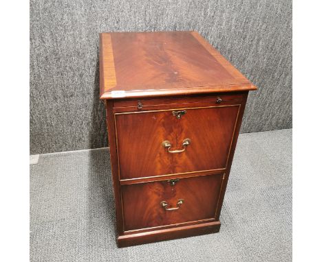 A two drawer flame and cross banded mahogany filing cabinet with pull out shelf 80 x 67 x 50cm.