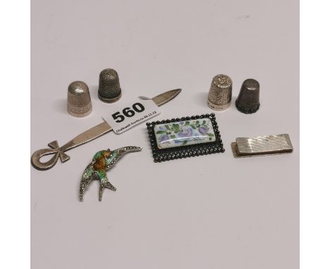A silver ankh bookmark with a silver money clip, silver and enamel brooch, four thimbles and a filigree brooch.