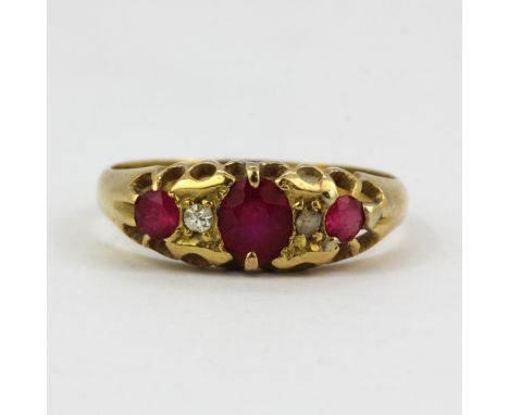 A hallmarked 18ct yellow gold diamond and ruby set ring, (R ). One replacement stone.