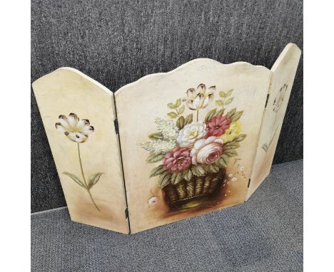 A hand painted firescreen with floral design, H. 78cm Total L. 115cm.